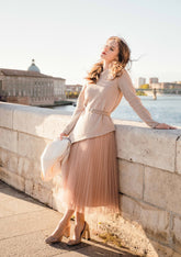 A lady wears a tulle skirt and sweater.